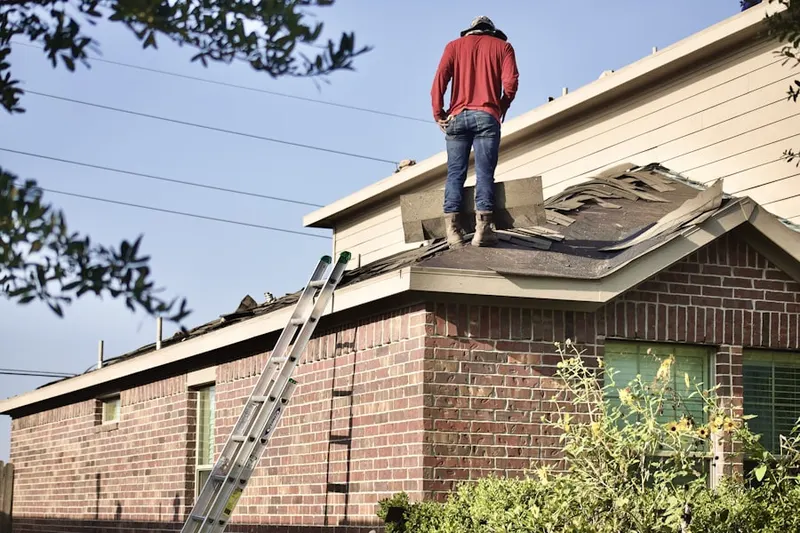 Professional roofer working on a residential roof in Woodland Way